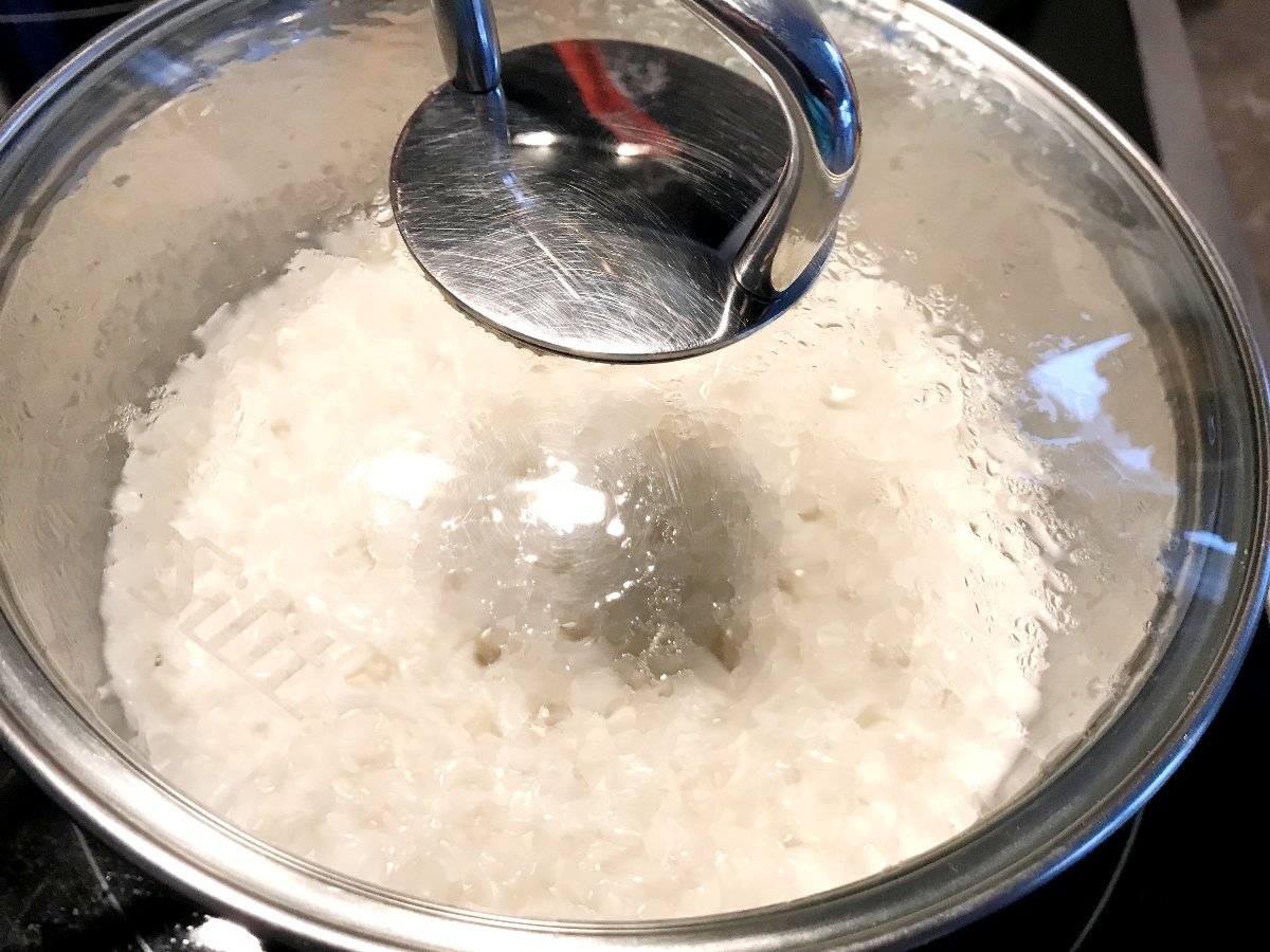 Basmati rice cooking in a small saucepan