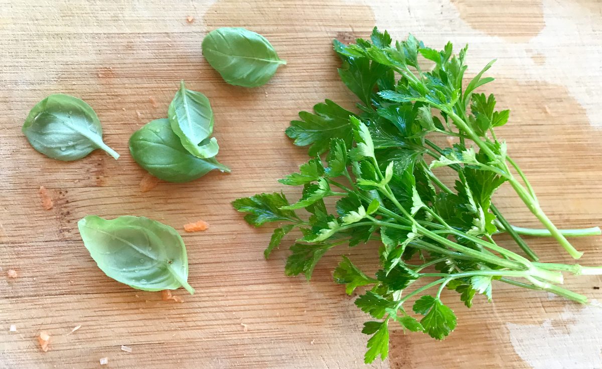 Parsley and basil on a cutting board