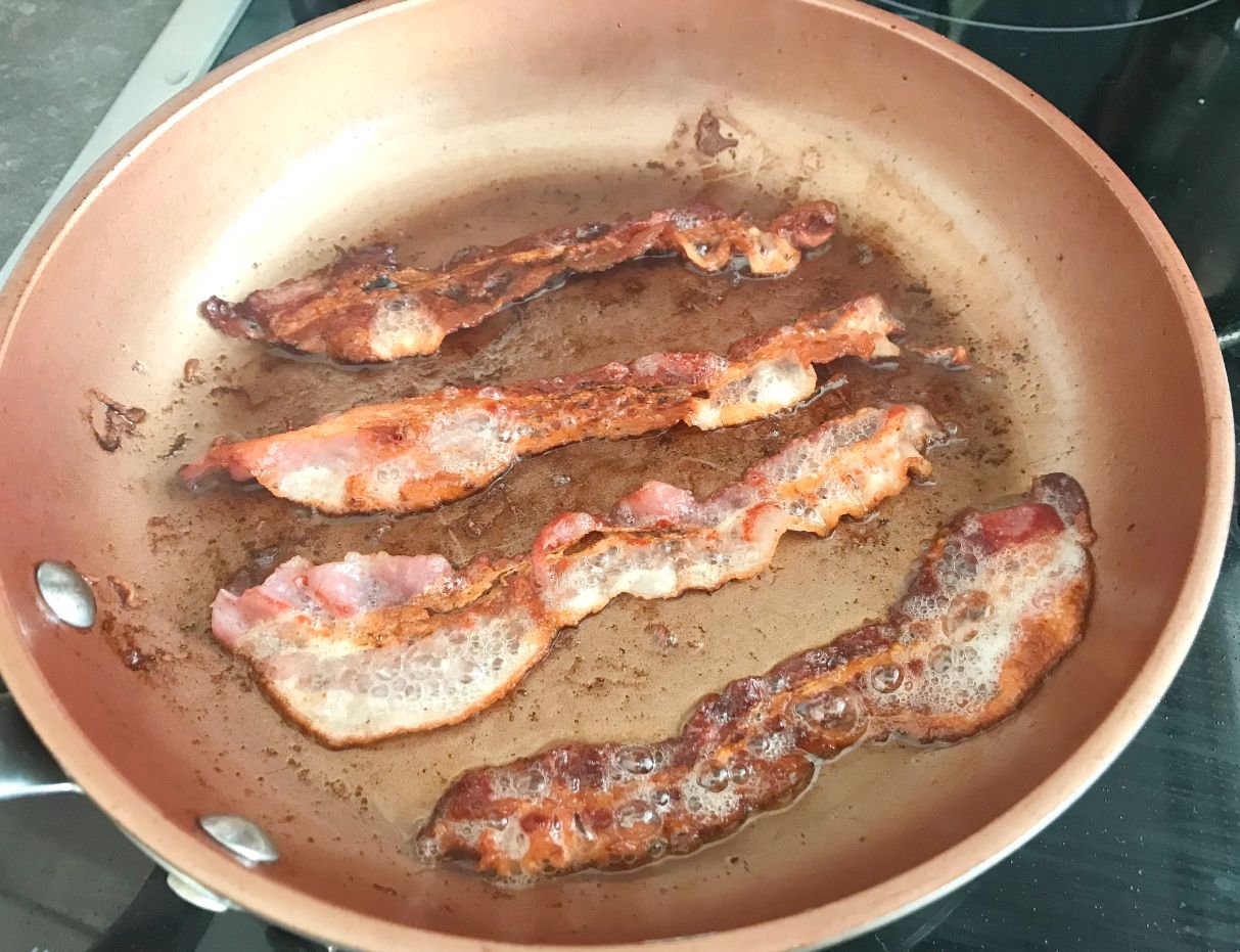 Fry bacon in pan