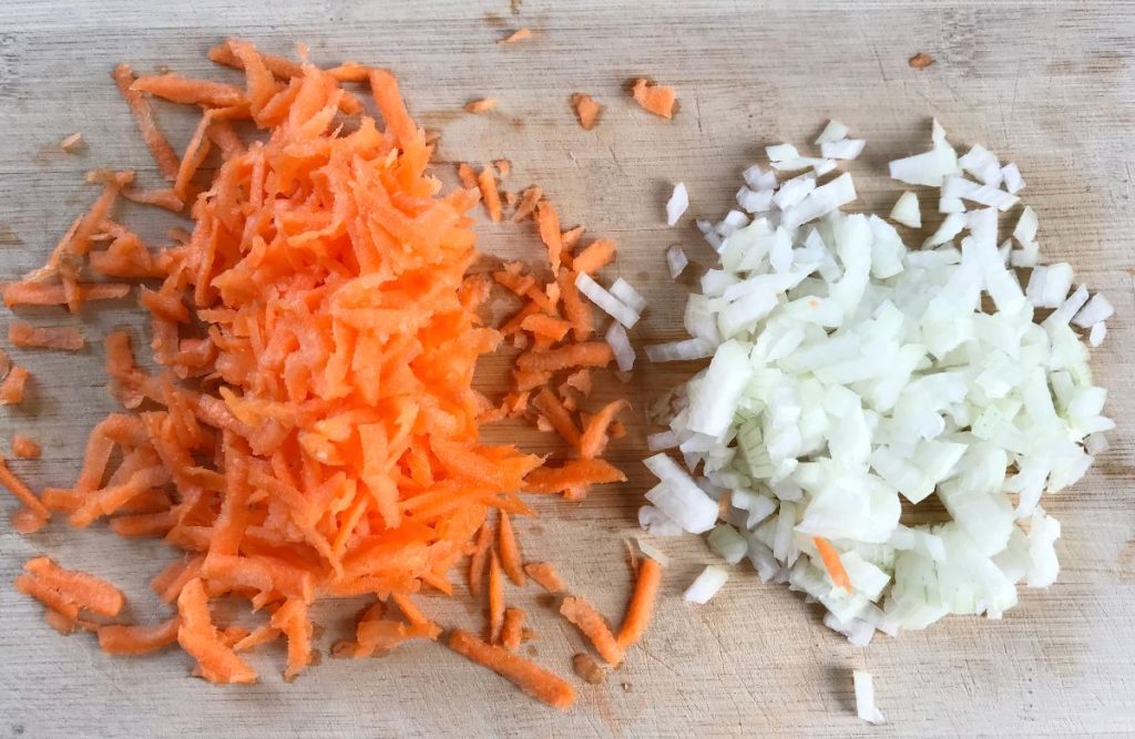 Grate carrots and dice onion