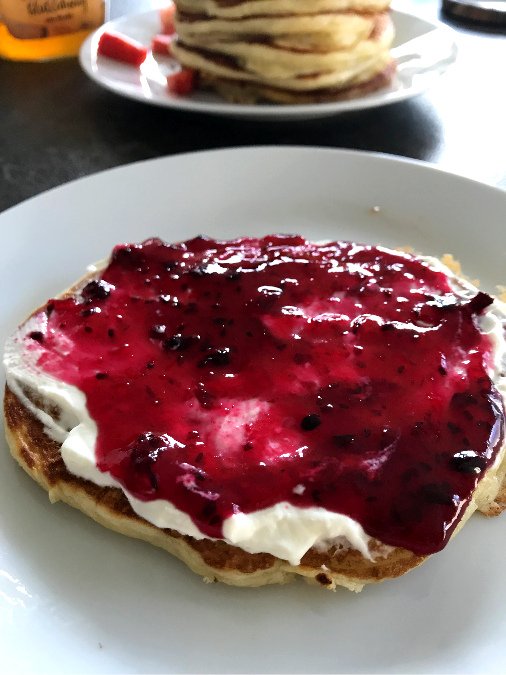 Pancake served with sour cream and jam