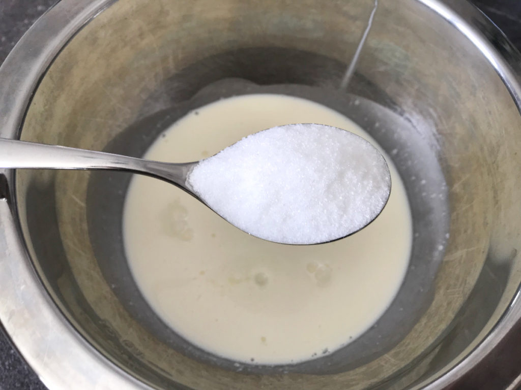 Add sugar to heavy whipping cream