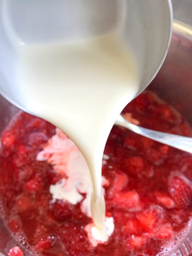 Add cream to strawberries