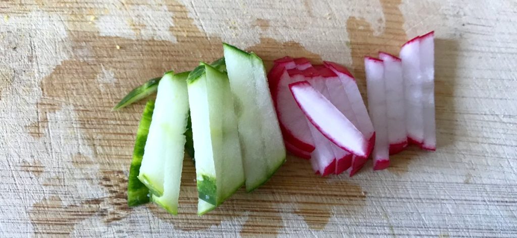 Cutting cucumbers and radishes with a knife