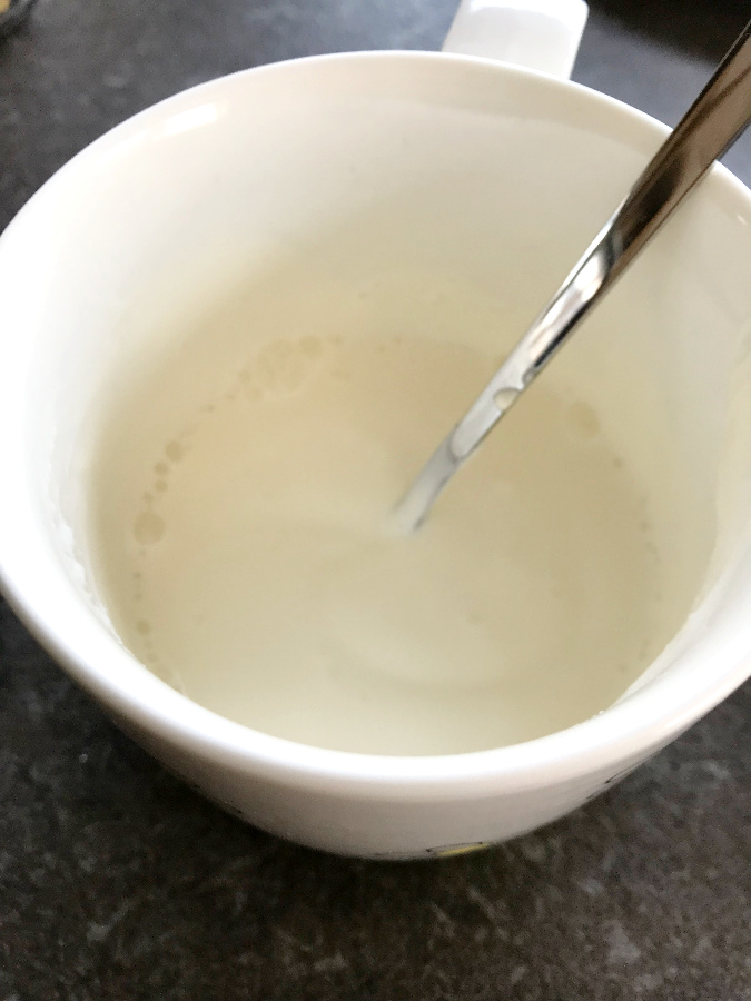 Sour cream and water mixed in a cup