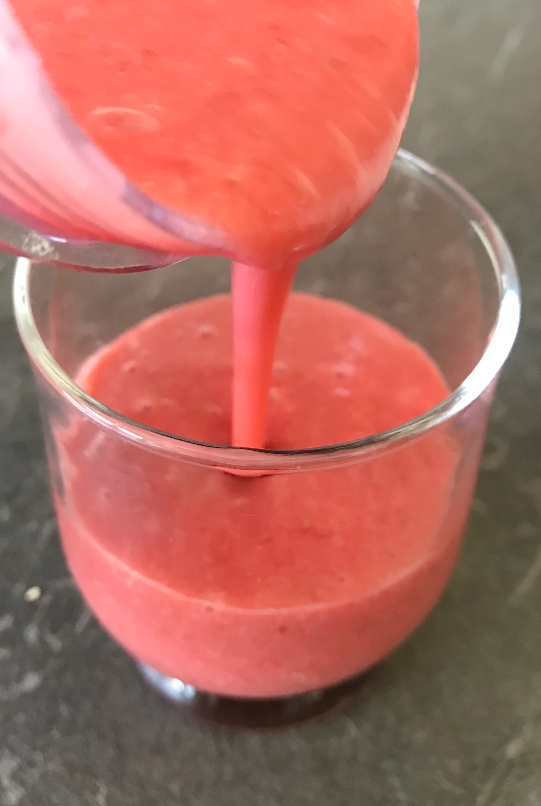Pour finished strawberry banana smoothie into glass