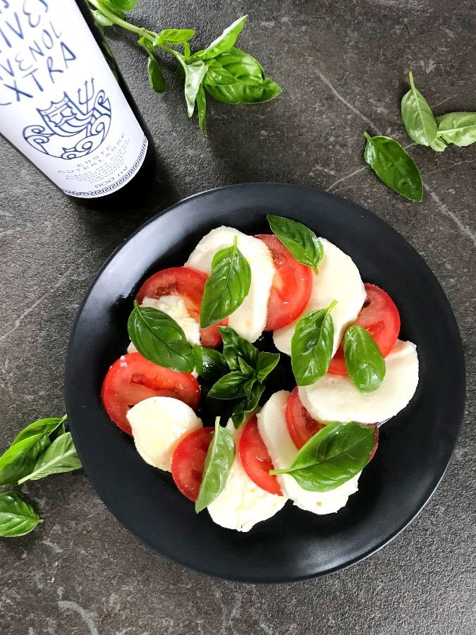 Tomato and Mozzarella slices served on black plate