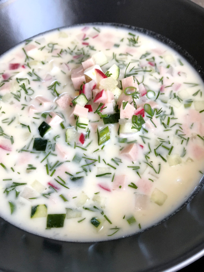 Okroshka cold soup served in a gray bowl.