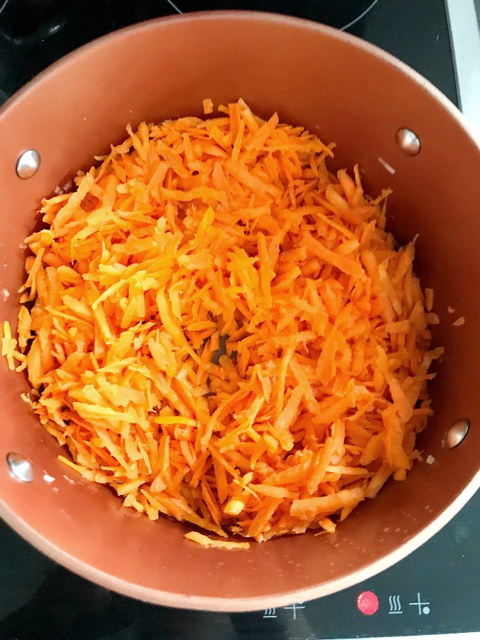 Carrots sautéing in a heavy bottomed pan