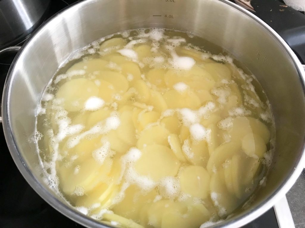 Potatoes boiling in pot