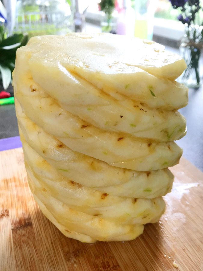 Sliced pineapple on cutting board