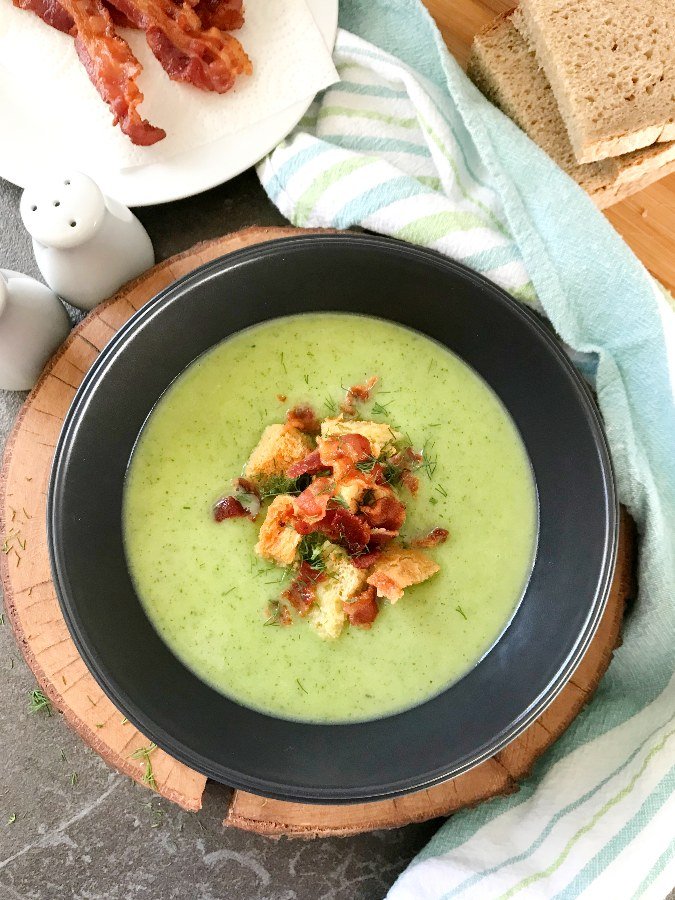 Creamy Zucchini Soup in gray bowl served with Bacon and croutons