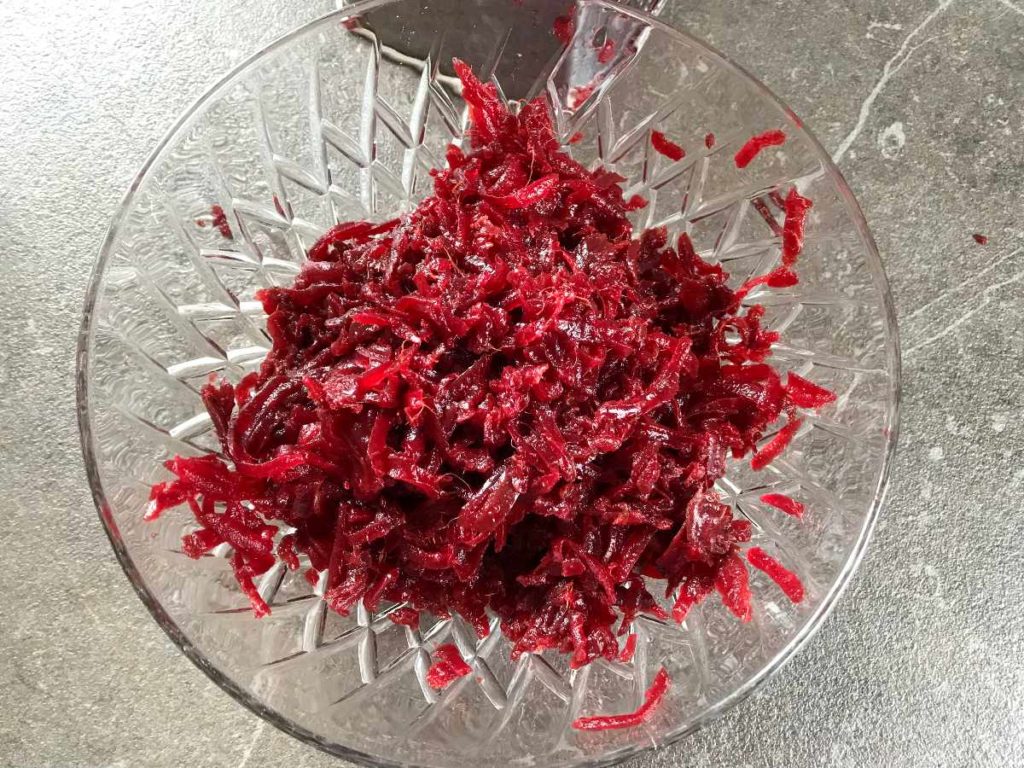 Grated red beets in a bowl