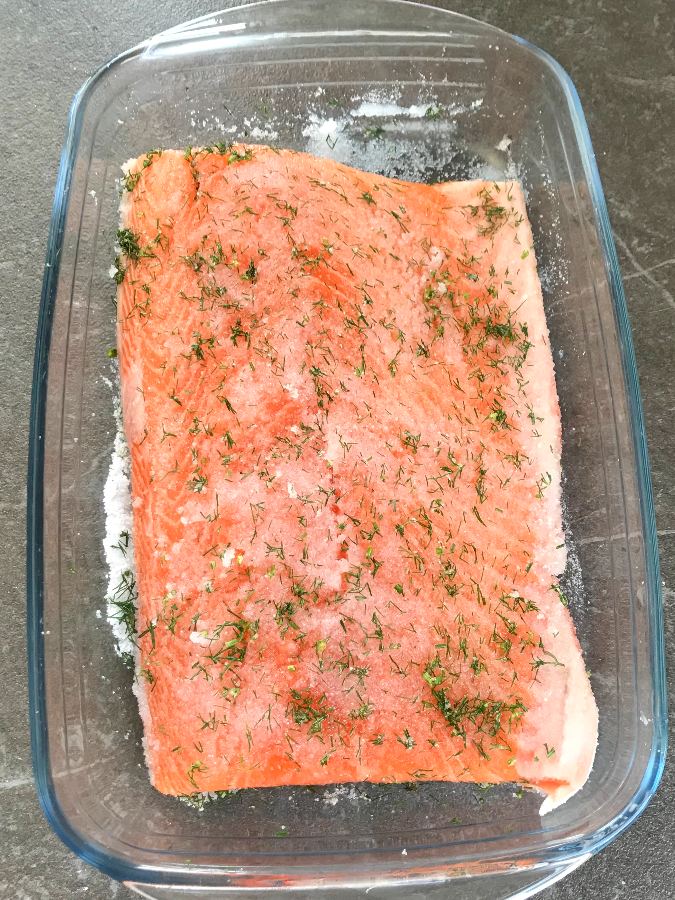 Salmon sprinkled with dill in a dish