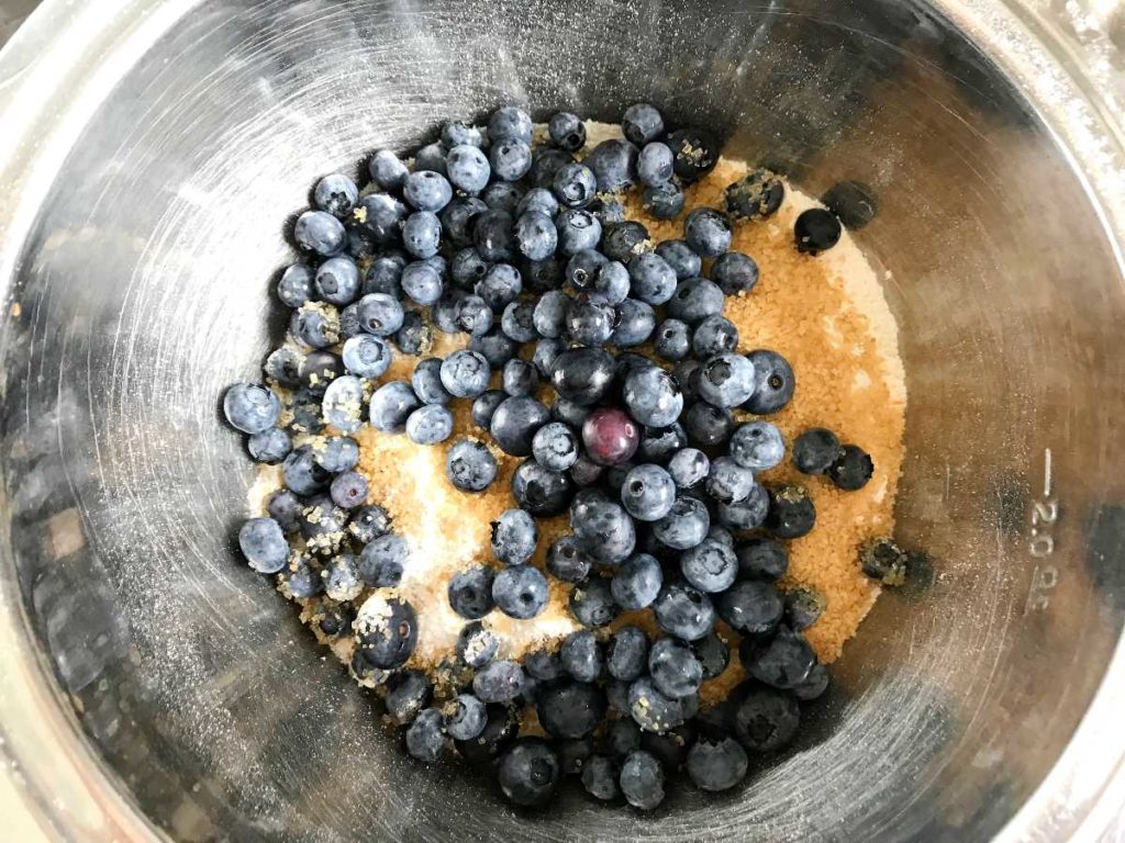 Blueberries in bowl with brown sugar and flour