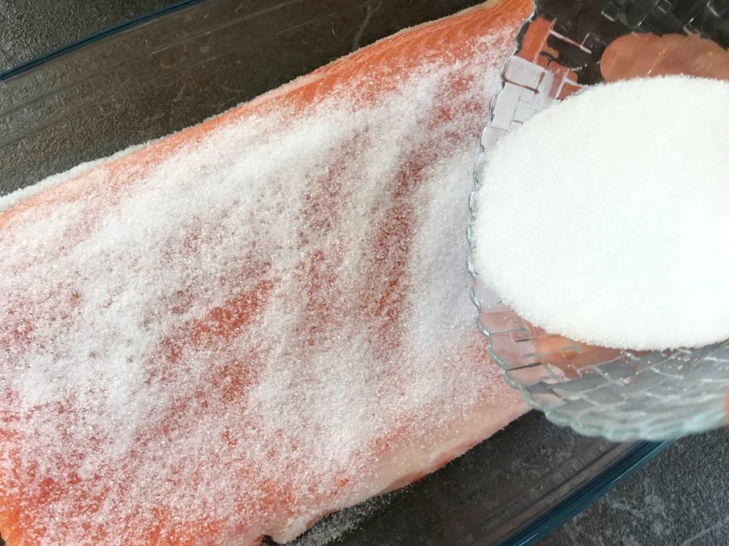 Salmon sprinkled with salt and sugar mixture