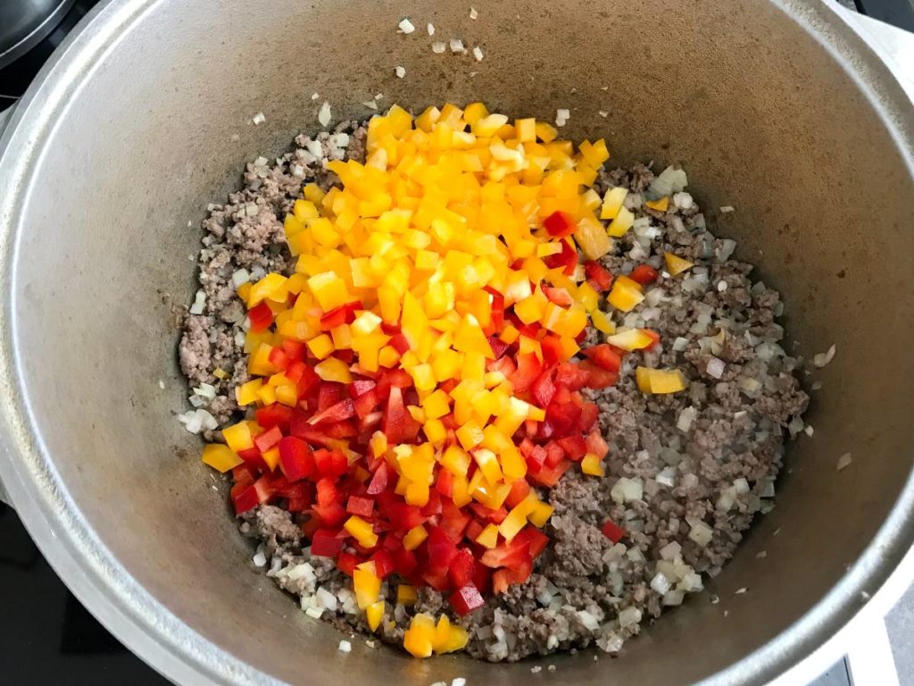 Pepper added to minced meat and onion.