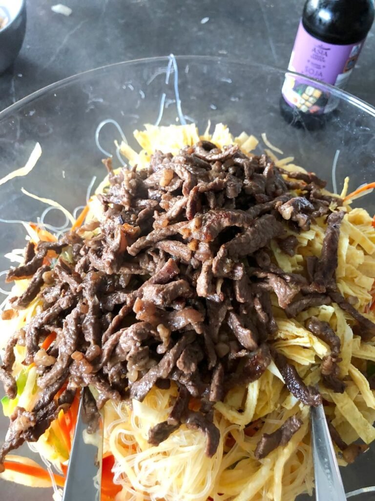 Thin beef pieces added to funchoza