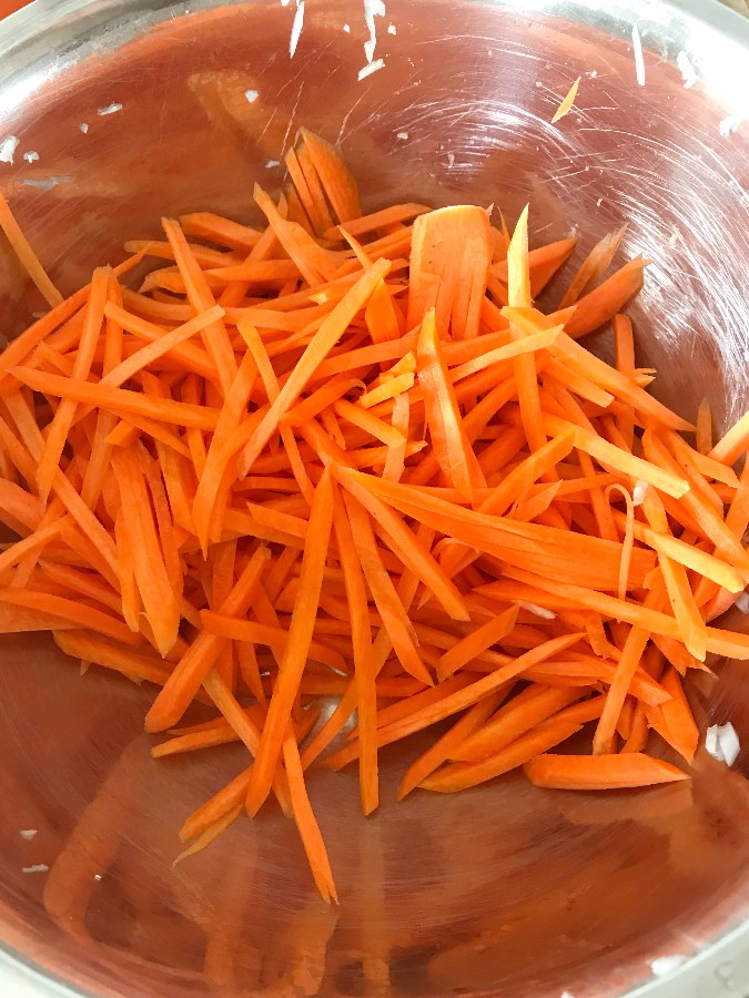 Julienned carrots in a bowl.