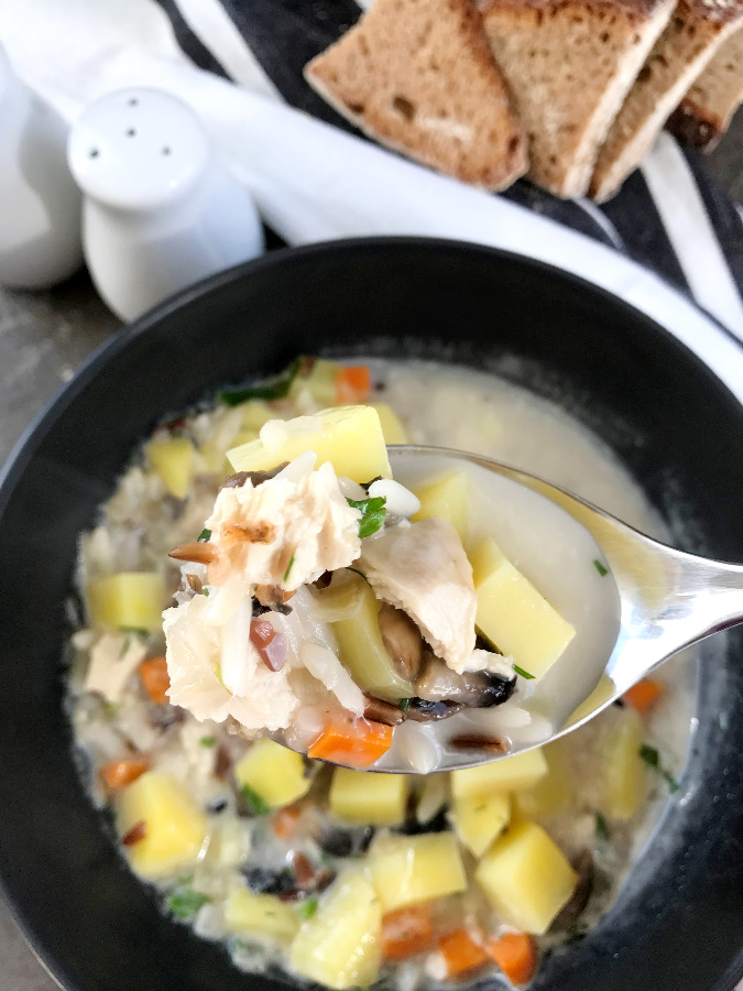Chicken wild rice Soup with Mushrooms on a tablespoon.