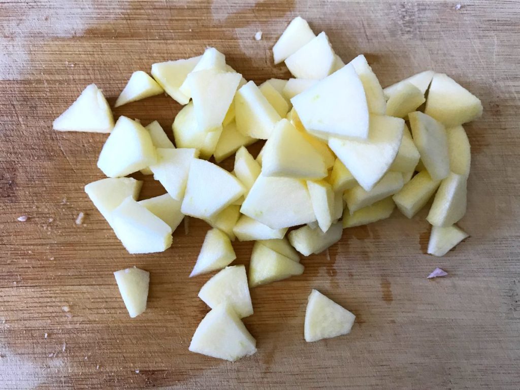 Chopped apples on a cutting board.