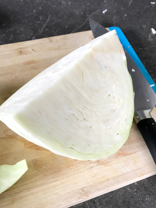 Cabbage cut into fourths for easier shredding to make sauerkraut.