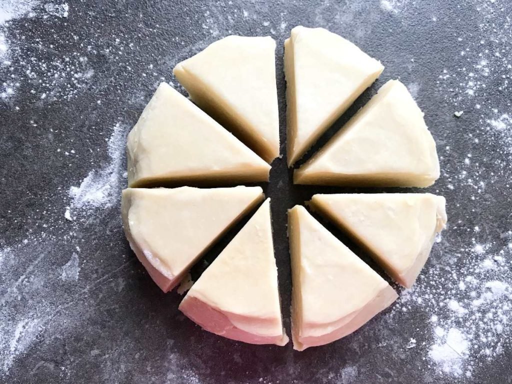 Rugelach dough divided into 8 pieces.