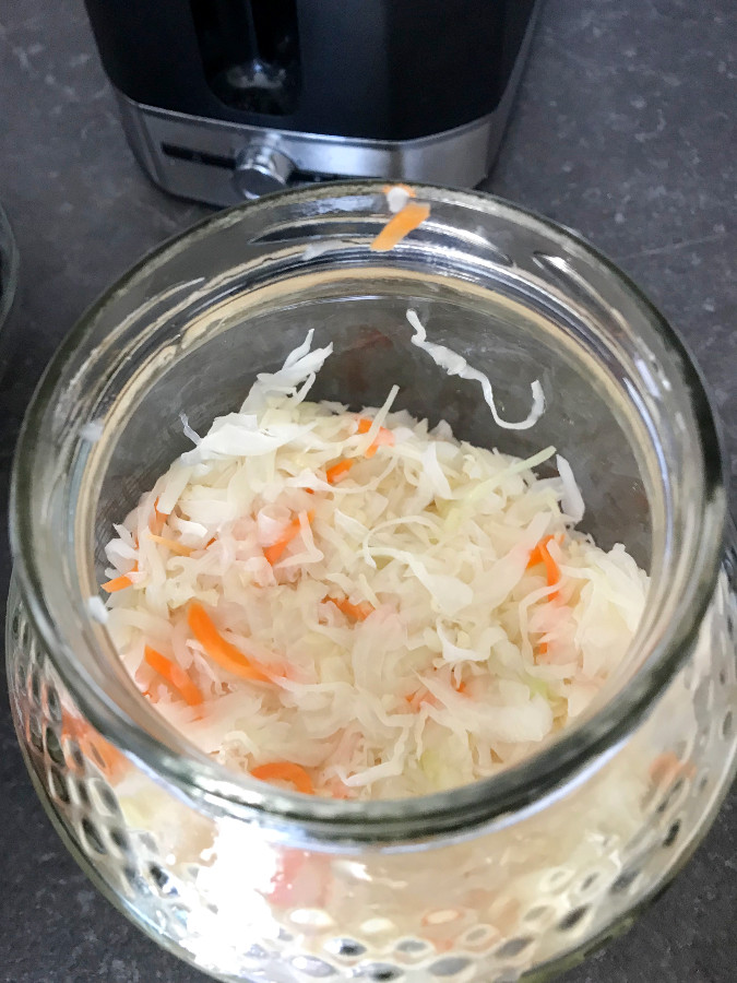 Homemade Sauerkraut packed in a glass jar.