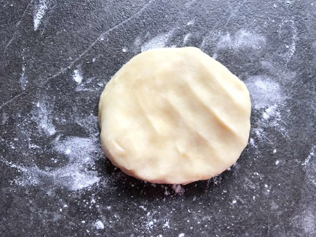 Rugelach dough pressed into a patty.