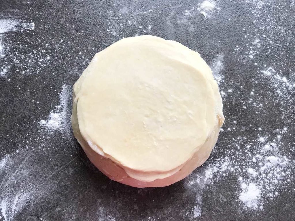 Rugelach dough rolled out with rolling pin.