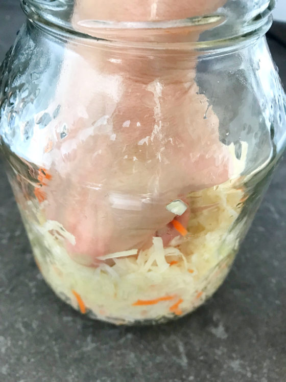 Quick Homemade Sauerkraut Emkayskitchen   Sauerkraut Being Tightly Packed In A Glass Jar 560x747 