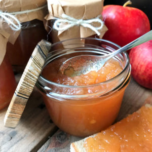 Apple jam without pectin in a jar and served on bread.