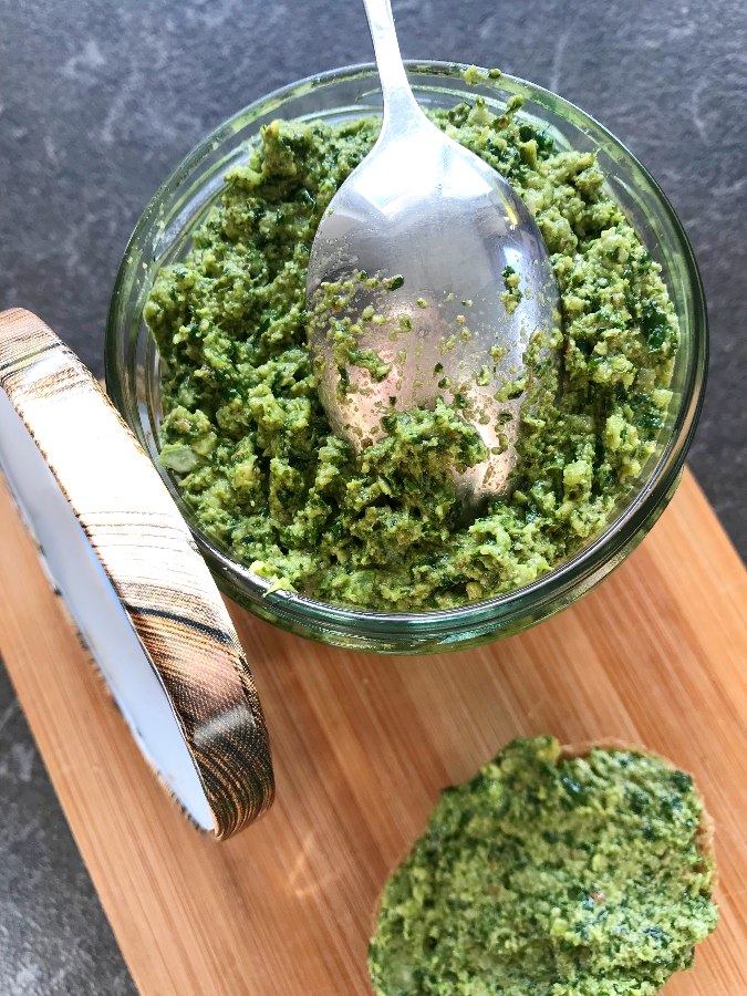 Cilantro spread, cilantro sauce in a jar and spread on a piece of bread.