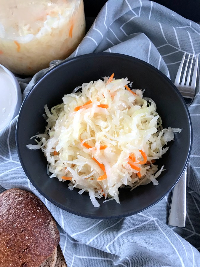Homemade Sauerkraut served in a black serving bowl