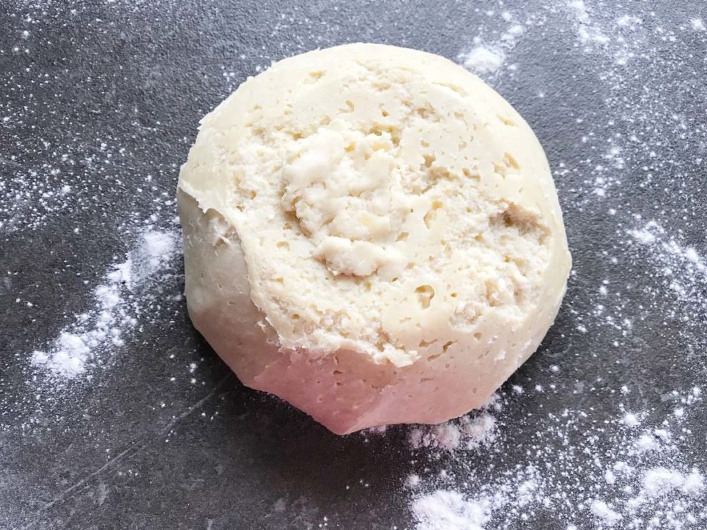 Rugelach dough from fridge layed out on floured surface.