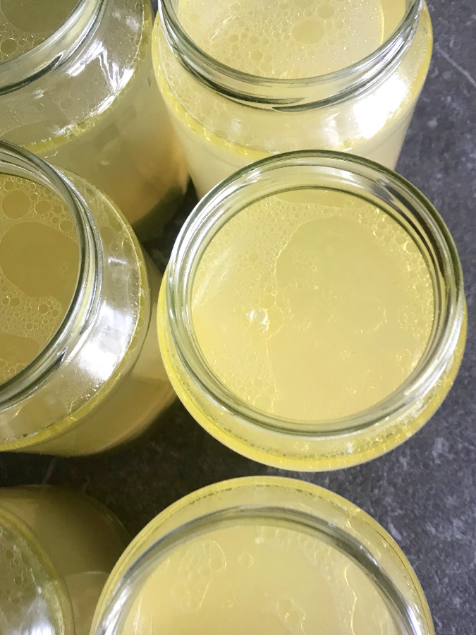 Homemade chicken broth filled in jars