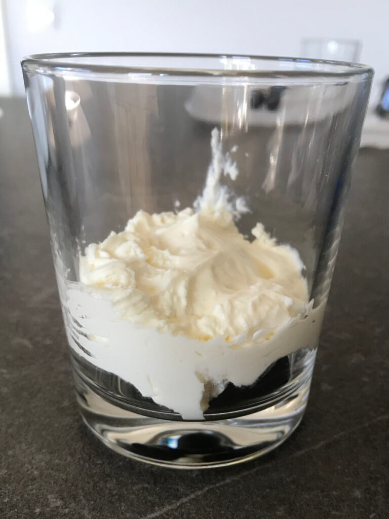 Cream layer added to the dessert glass.