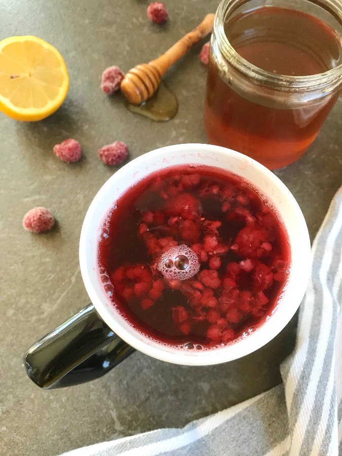 Raspberry Tea for Colds with Lemons and Honey served in a mug