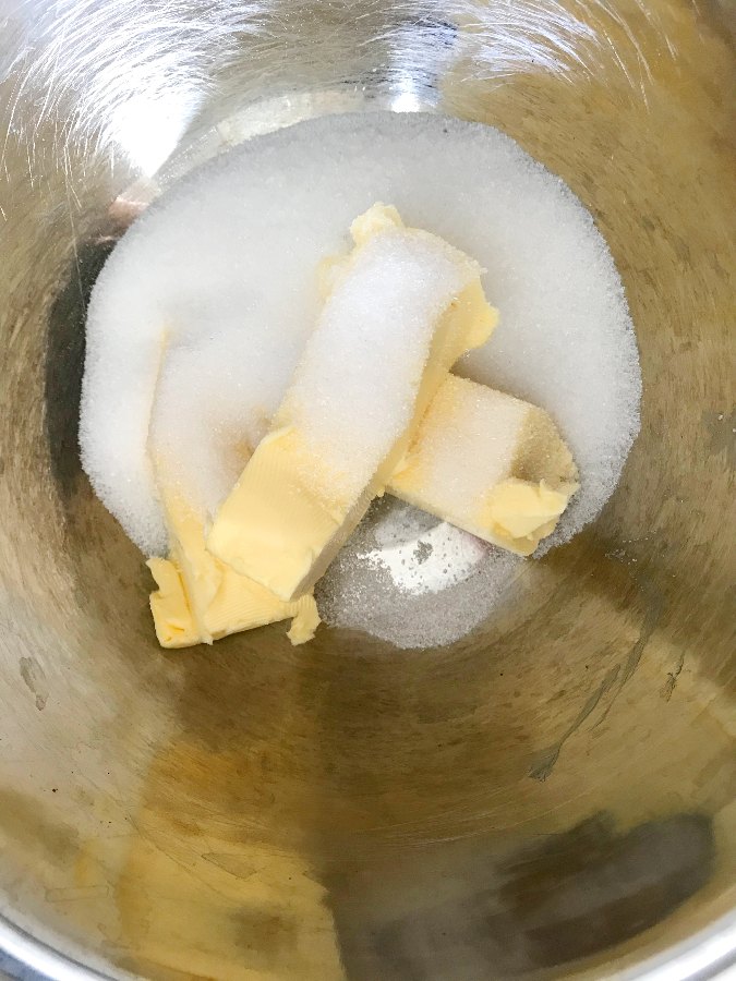 Butter and sugar in a stainless steel bowl
