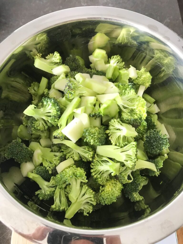 Broccoli florets in a stainless steel bowl