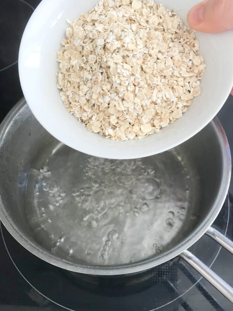 Oatmeal added to boiling and salted water.