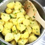 Butter Potatoes with parsley in a pot.