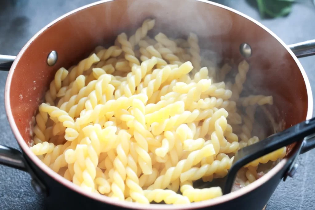 Hot Gemelli pasta added to the sauce in one pot.