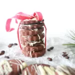 Coffee Cookies with white chocolate stacked and tied with a ribbon.