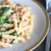 Gemelli Pasta served on a dinner plate with a fork on the side.