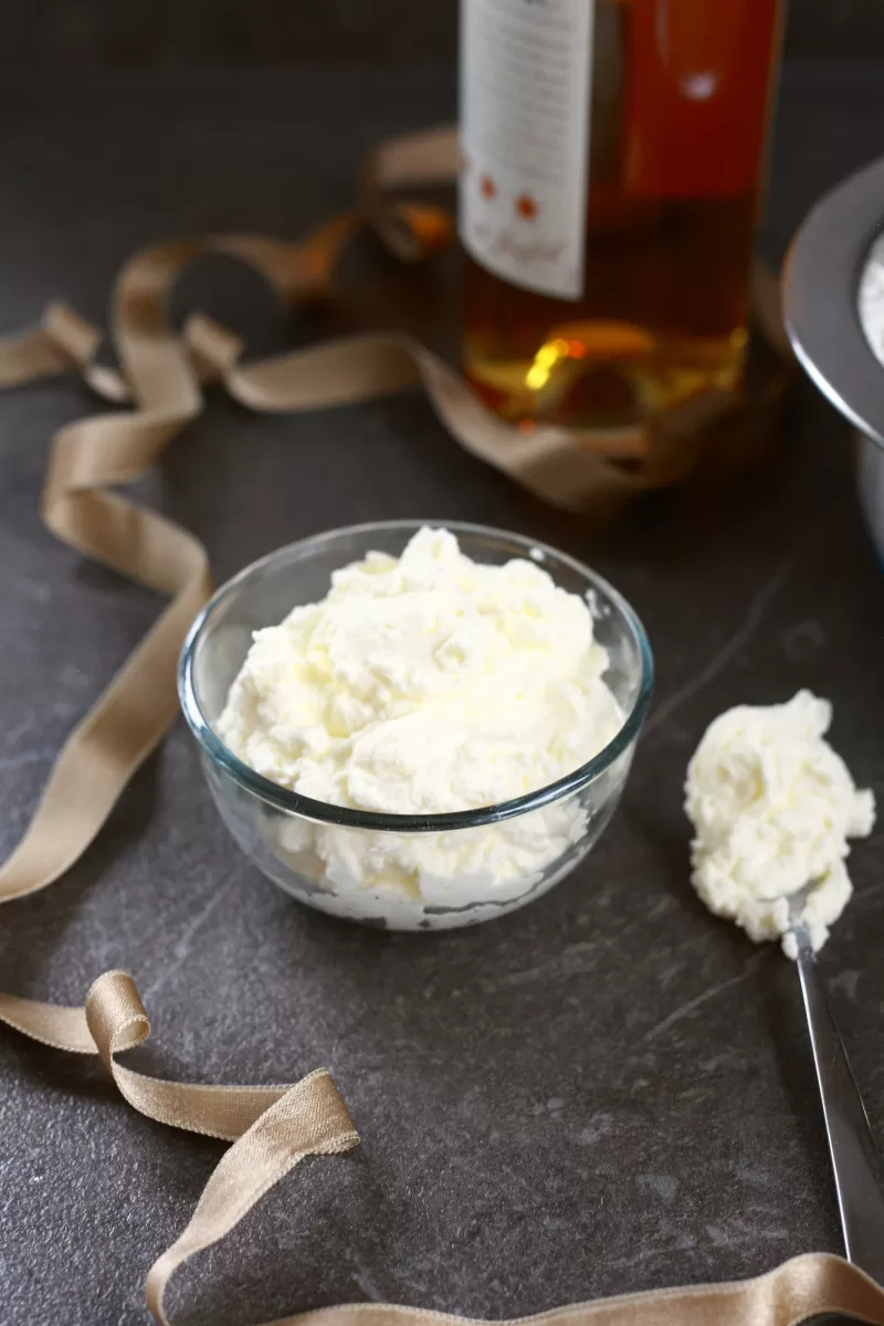 Alcoholic whipped cream with cognac in a glass bowl.