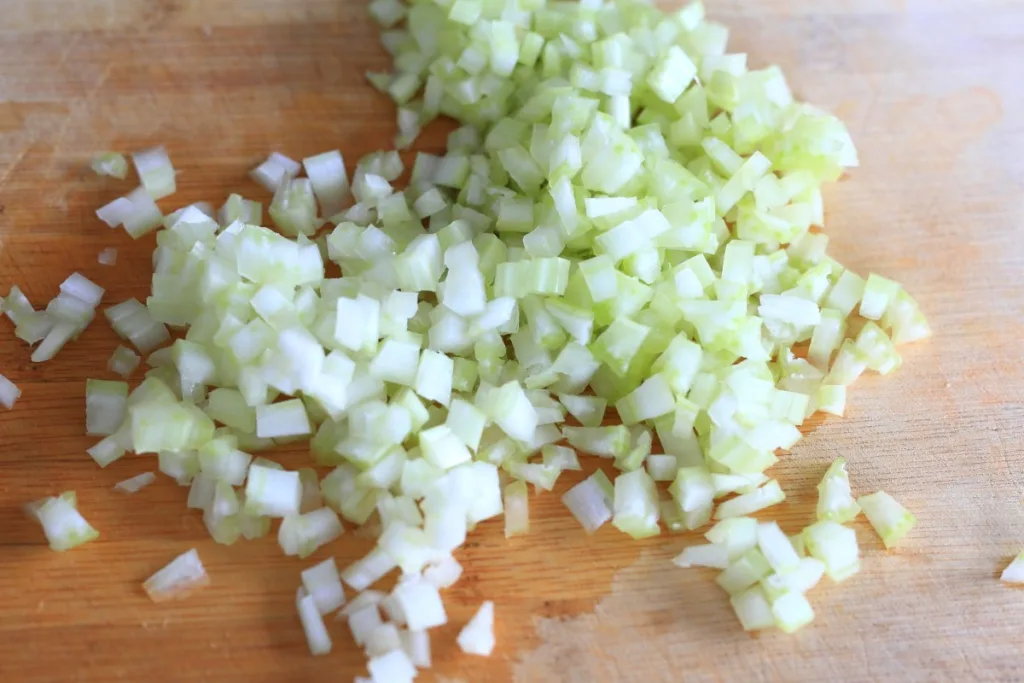 Chopped celery on a cutting board.