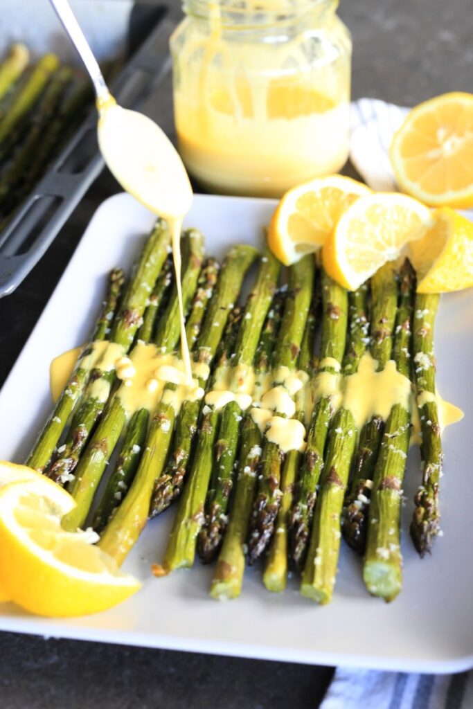 Roasted Garlic Asparagus with immersion blender hollandaise served on a plate.