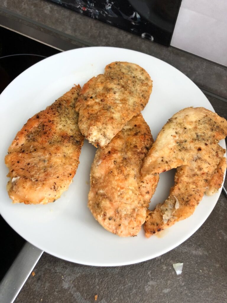Fried chicken breasts on a plate.