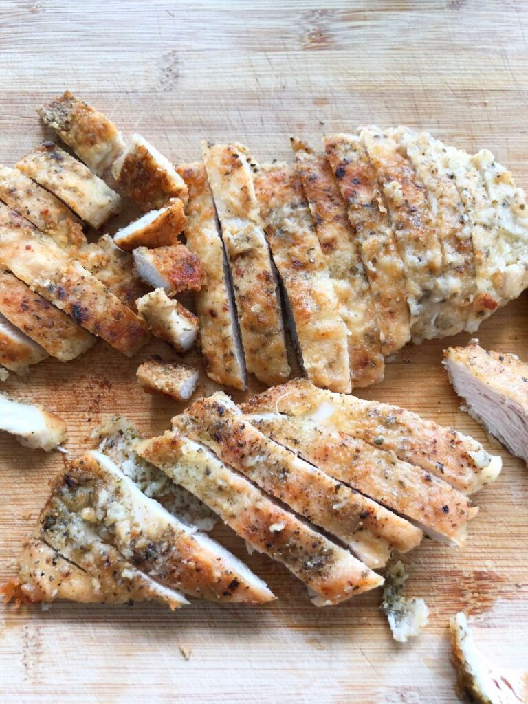 Sliced Marry Me chicken on a cutting board